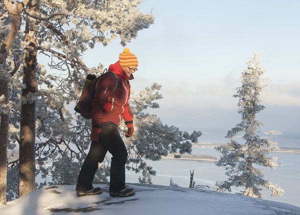 Image: Person walking with snowspikes in Koli hills.